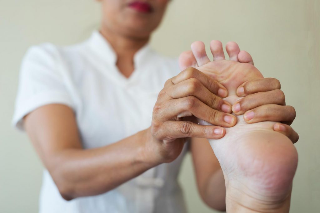 close up woman doing foot massage spa