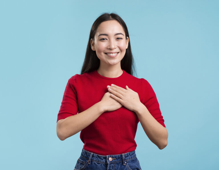 smiley female with hands heart