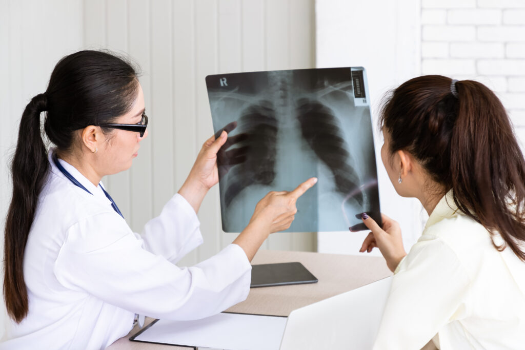 Medical doctor give consultation to patient with x ray film